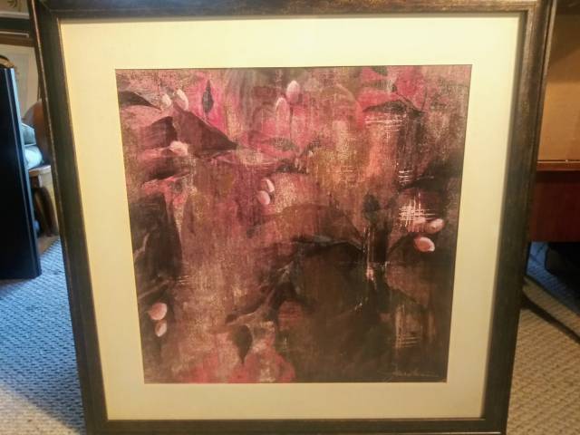 Framed art piece under glass